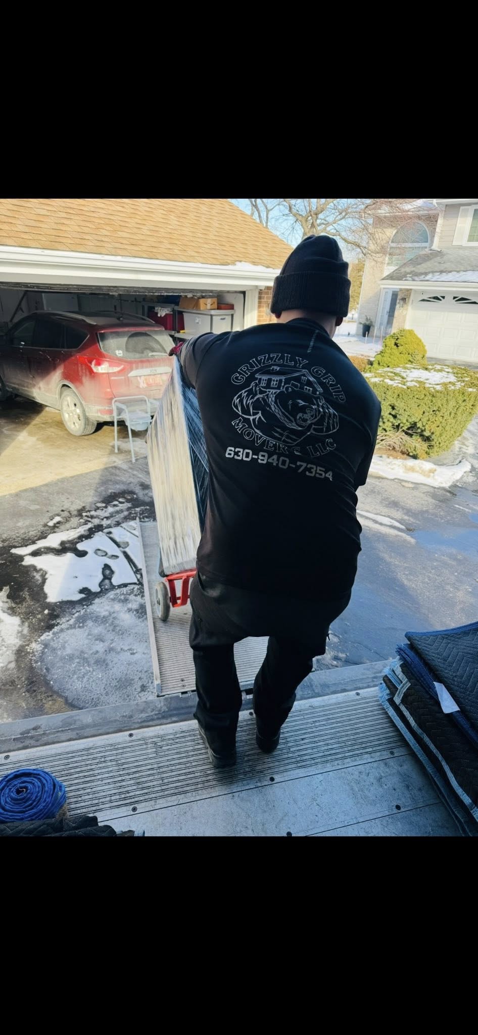 Grizzly Grip mover with branded shirt on truck ramp